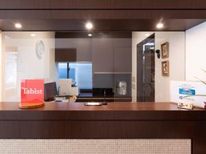 a view of a kitchen with a counter top at Chang Tee Hotel Ikebukuro in Tokyo