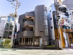 a building with a sign on the side of it at Chang Tee Hotel Ikebukuro in Tokyo