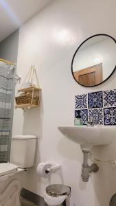 La salle de bains est pourvue d'un lavabo, d'un miroir et de toilettes. dans l'établissement Aloja-T en Apartamento amoblado 4 en Ciudad Bolivar, à Ciudad Bolívar