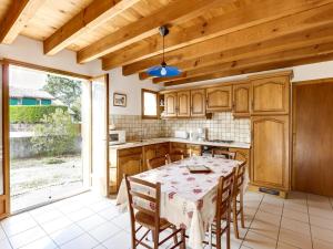 a kitchen with a table and wooden cabinets at Biscarrosse Plage: Villa 4 pièces avec terrasse, proche océan - FR-1-521-54 in Biscarrosse-Plage