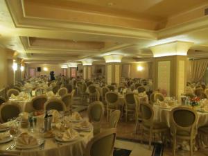 a banquet hall with white tables and chairs at Club Hotel Kennedy in Roccella Ionica +60 photos