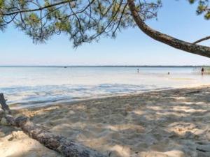 a view of a beach with people in the water at Appartement T3 avec piscine, sauna en front de mer à Biscarrosse Plage - FR-1-521-1 in Biscarrosse-Plage