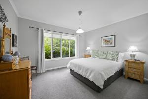 a bedroom with a large bed and a window at Amelina Cottages in Marysville