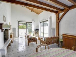 a living room with a fireplace and a table and chairs at Maison Biscarrosse Plage, 4 pièces, 8 personnes - FR-1-521-94 in Biscarrosse-Plage