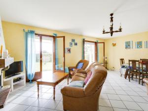a living room with two couches and a table at Maison plain-pied à Biscarrosse avec jardin clos, terrasse et parking pour 6 personnes - FR-1-521-105 in Biscarrosse