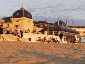 a group of people on the beach near a building at Appartement T2 à 50m de la plage avec piscine, tennis et balcon - Châtelaillon-Plage - FR-1-535-4 in Châtelaillon-Plage +6 photos