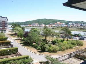 a view of a street with trees and a river at Appartement 3 pièces en front de mer avec balcons, à Cabourg, proche centre-ville. - FR-1-487-275 in Cabourg
