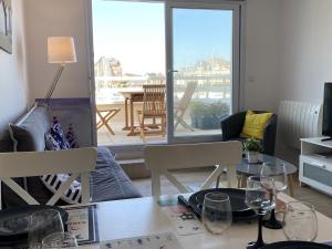 a dining room with a table with wine glasses on it at Bel Appartement Duplex 4 pièces avec Vue sur Port et Terrasse - FR-1-487-314 in Dives-sur-Mer