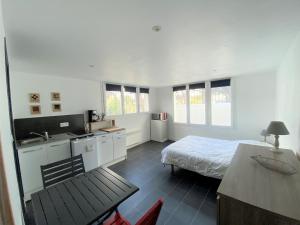 ein Schlafzimmer mit einem Bett und eine Küche mit einem Waschbecken in der Unterkunft Maison Saint-Palais-sur-Mer, 5 pièces, 8 personnes - FR-1-539-22 in Saint-Palais-sur-Mer