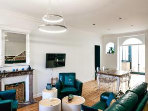 a living room with a couch and a fireplace at Maison de Charme 4 Chambres, 50m de la Mer, Centre des Sables d'Olonne - FR-1-197-508 in Les Sables-dʼOlonne