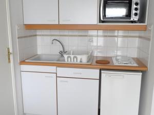 a kitchen with a sink and a microwave at Appartement 2 pièces avec piscine et parking à Dives-sur-Mer - FR-1-487-294 in Dives-sur-Mer