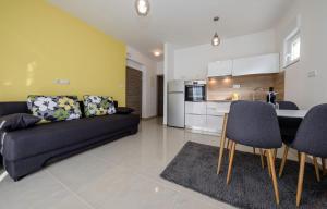 a living room with a couch and a kitchen at Apartments Biserka G in Palit +38 photos