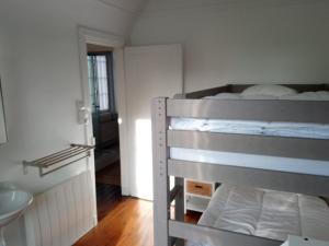 a bedroom with a bunk bed and a bathroom at Maison Cabourg, 4 pièces, 4 personnes - FR-1-487-326 in Cabourg