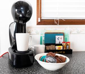 a coffee maker sitting on a counter next to a bowl at Edithburgh Caravan Park in Edithburgh