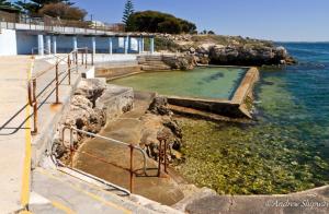 a swimming pool in the water next to the ocean at Edithburgh Caravan Park in Edithburgh