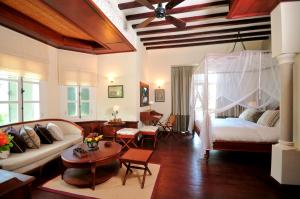 a bedroom with a bed and a living room at The Luang Say Residence in Luang Prabang +66 photos
