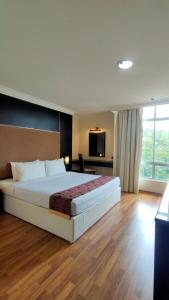 a hotel room with a bed and a television at The Jerai Hotel Sungai Petani in Sungai Petani