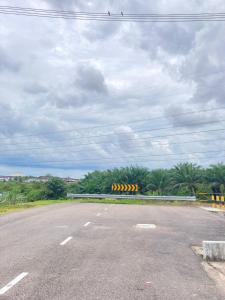 an empty road with a bunch of yellow and black objects at D’Anom Homestay in Kluang