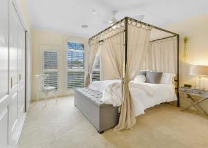 a bedroom with a canopy bed and a window at Roselawn Manor - 5 Bedroom Entertainer in Orange