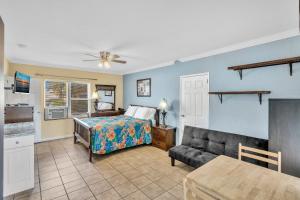 a bedroom with a bed and a couch at Charter House in Hollywood