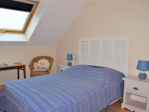 Un dormitorio con una cama azul y una ventana en Appartement Trégastel, 3 pièces, 4 personnes - FR-1-368-11, en Trégastel
