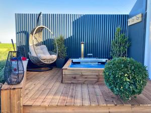 a small pool on a wooden deck with a swing at Libertas Guest Farm in Hoekwil