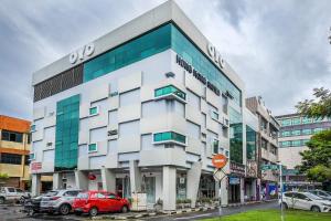 a building with cars parked in front of it at Super OYO 977 Hong Kong Suites in Miri