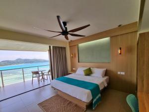 a bedroom with a bed and a view of the ocean at VILLA KIKI Seychelles in Anse a La Mouche