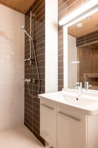 a bathroom with a sink and a shower at 2ndhomes Helsinki Center Apartment with Sauna in Helsinki