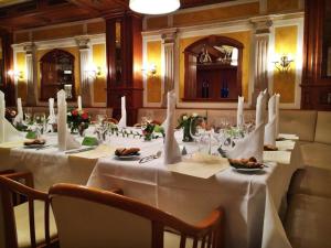 a table with white table cloths on it in a restaurant at Stadthotel Restaurant Auerhahn in Vöcklabruck