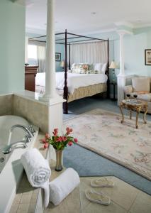a bedroom with a bed and a bath tub and a sink at Hampton Terrace Inn in Lenox