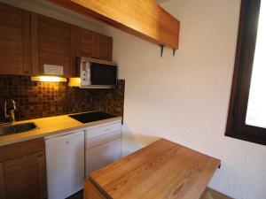 a kitchen with a sink and a microwave at Appartement Auris, 1 pièce, 4 personnes - FR-1-297-117 in Auris