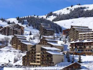 a group of buildings on a snow covered mountain at Appartement Auris, 3 pièces, 6 personnes - FR-1-297-156 in Auris