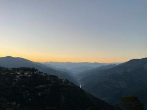 a view of a mountain valley at sunset at Flower Patch Homestay in Kalimpong