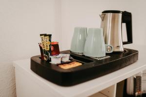a black counter top with a coffee maker on it at Hotel Garni Villa am Schaalsee in Zarrentin