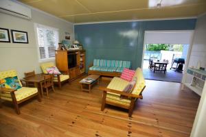 a living room with chairs and a couch at 23 Bryce St Moffat Beach in Caloundra