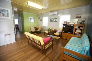 a living room with a couch and a dining room at 23 Bryce St Moffat Beach in Caloundra
