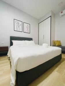 a bedroom with a large white bed in it at Urban Serviced Apartment in Bandar Penawar