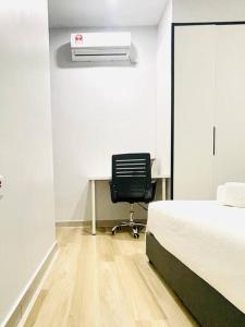 a bedroom with a bed and a desk with a heater at Urban Serviced Apartment in Bandar Penawar