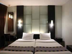 Postel nebo postele na pokoji v ubytování Swana Bangkok Hotel