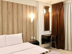 Postel nebo postele na pokoji v ubytování Swana Bangkok Hotel