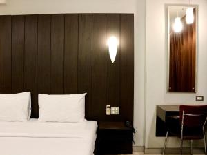 Postel nebo postele na pokoji v ubytování Swana Bangkok Hotel
