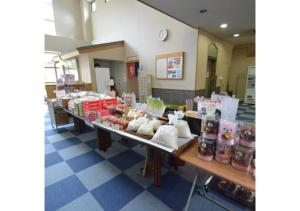 a store with a long table filled with food at Isawa no sato / Vacation STAY 61566 in Shiso