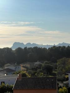 a view of a city with mountains in the distance at La désirade full south in La Ciotat