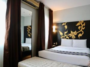 Postel nebo postele na pokoji v ubytování Swana Bangkok Hotel
