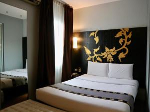 Postel nebo postele na pokoji v ubytování Swana Bangkok Hotel