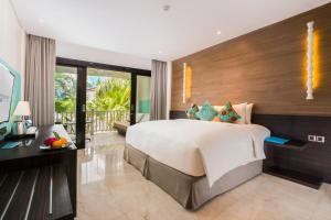 a bedroom with a large bed and a balcony at Montigo Resorts Seminyak in Seminyak +73 photos