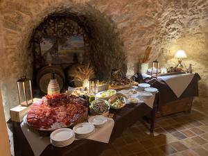 a table with many plates of food on it at Slow holidays in Calabria tradizioni eno-gastonomia tra borgo e mare in Badolato