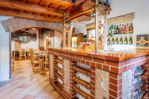 a bar in a restaurant with a brick wall at Stara Plynarna in Hřensko