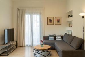 a living room with a couch and a television at Esperos Studios and Apartments, #1 and #5 in Stalís